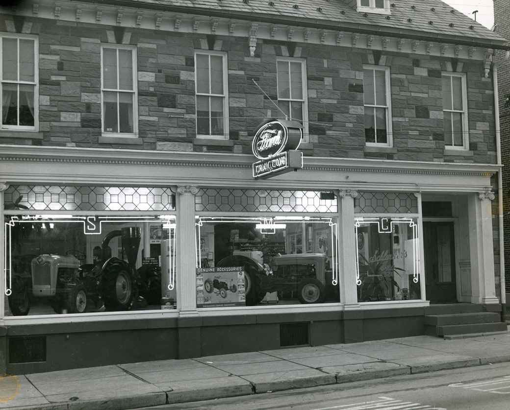 A variety of Ford tractors on display at Schlenker Motors (328 W. Main Street, currently Deturk's Hardware). From the KAHS Collection.